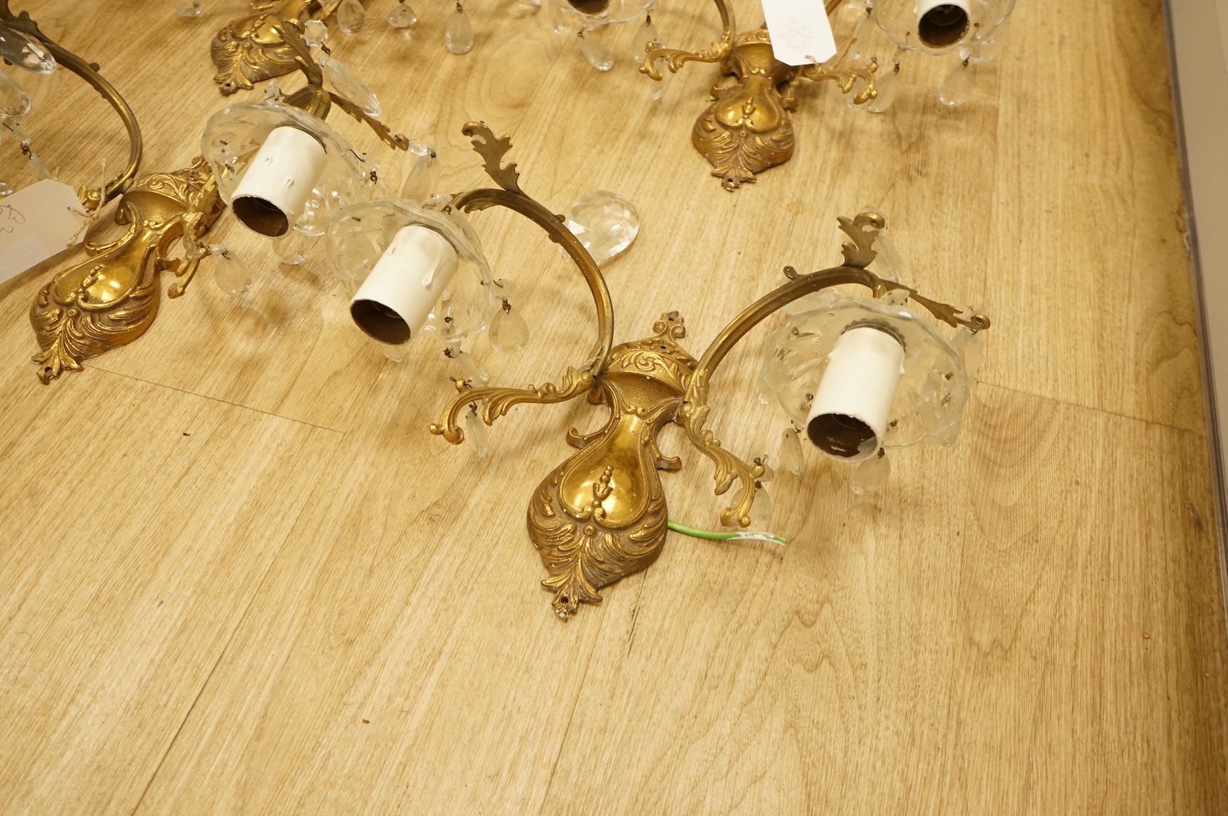 Five cast brass and glass wall lights